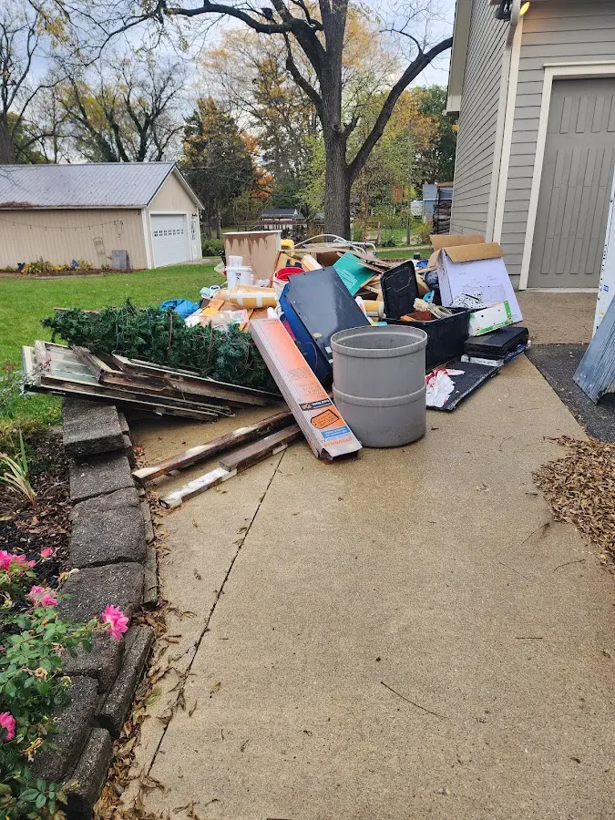 Dumpster being loaded with debris for Roofing Dumpster Rental in White Creek